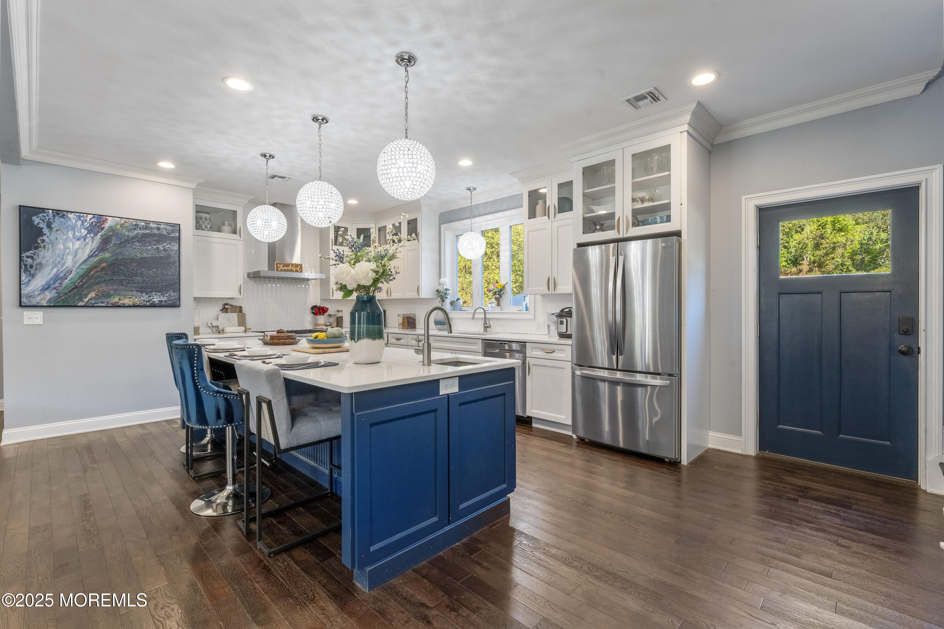 832 Holmdel Road Holmdel, NJ 07733 - Photo 12 of 44 a kitchen with stainless steel appliances kitchen island granite countertop a refrigerator a stove a sink dishwasher a dining table and chairs with wooden floor