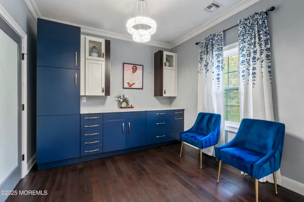 a living room with furniture and a dresser