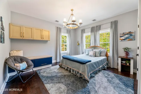 a bedroom with a bed and a chandelier