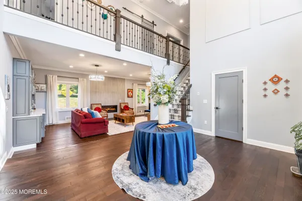 a living room with furniture flowerpot and wooden floor