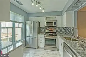 a kitchen with a stove microwave and refrigerator