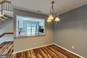 a view of a room with wooden floor and fan