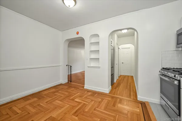 a view of a room with wooden floor
