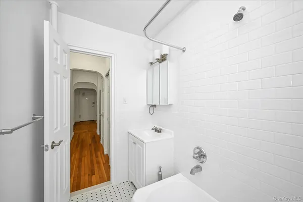 a bathroom with a sink and mirror with toilet