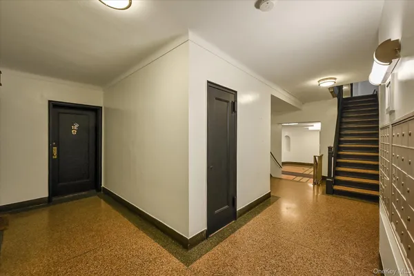 a view of hallway with stairs and wooden floor