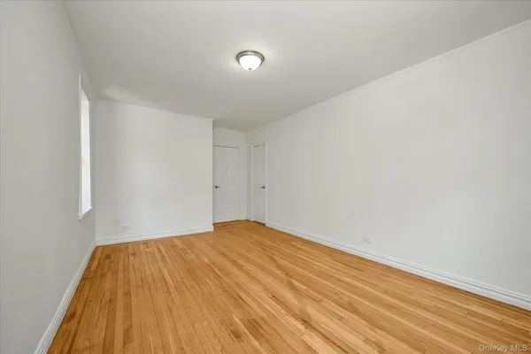 a view of a room with wooden floor