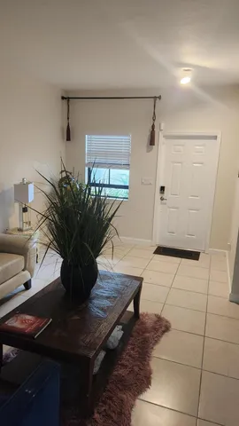 a room with furniture a chandelier and a window