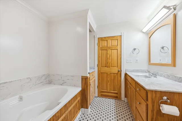 a bathroom with a sink a mirror and a bathtub