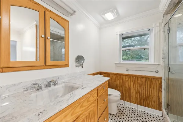 a bathroom with a granite countertop sink toilet and shower