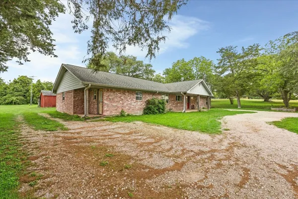a front view of house with yard and green space