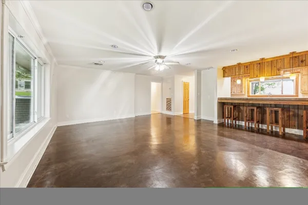 a view interior of a house wooden floor and a floor to ceiling window