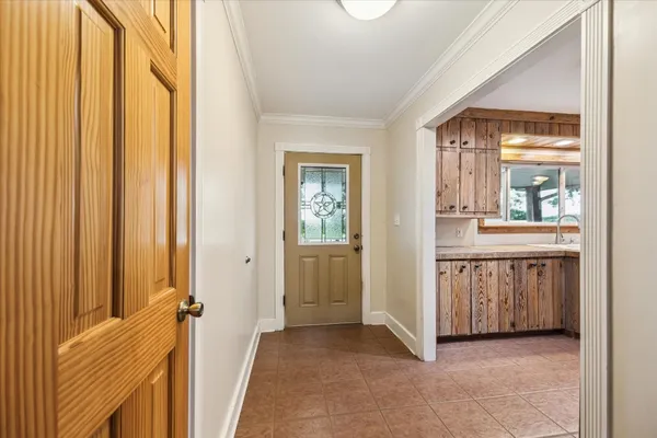 a view of a hallway with windows and entryway