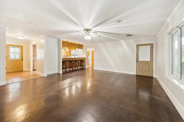 a view of an empty room with window and cabinet