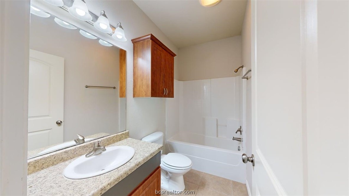 4453-4455 Reveille Road College Station, TX 77845 - Photo 17 of 37 a bathroom with a sink a toilet and shower a mirror