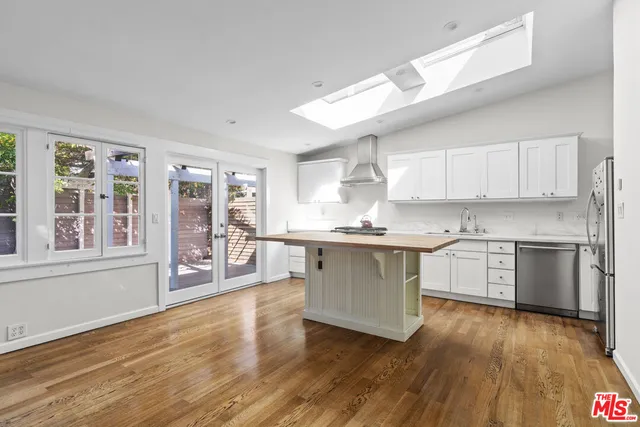a kitchen with a stove cabinets and wooden floor
