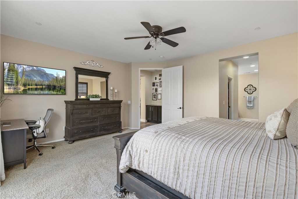 24903 Shadow Ridge Court Valencia, CA 91354 - Photo 24 of 43 a bedroom with a bed and a chandelier