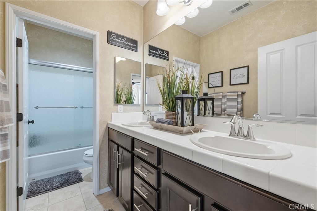 24903 Shadow Ridge Court Valencia, CA 91354 - Photo 32 of 43 a bathroom with a sink double vanity and a mirror