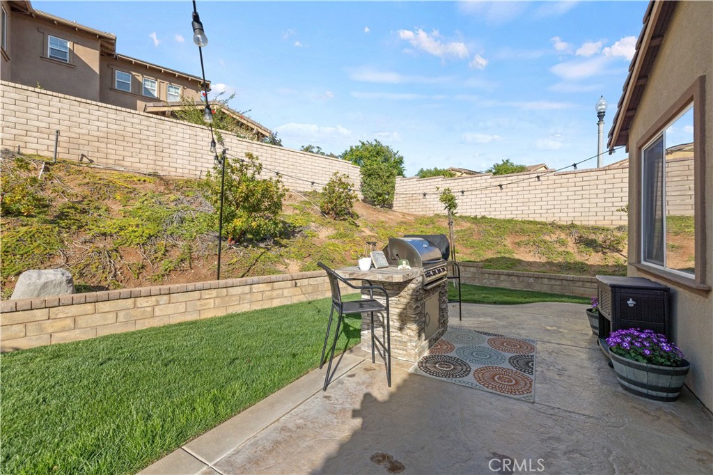 24903 Shadow Ridge Court Valencia, CA 91354 - Photo 35 of 43 a view of a patio with lawn chairs floor to ceiling window and yard
