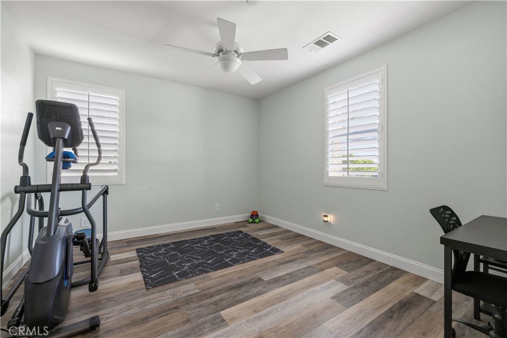 24903 Shadow Ridge Court Valencia, CA 91354 - Photo 6 of 43 a view of workspace with wooden floor ceiling fan and windows