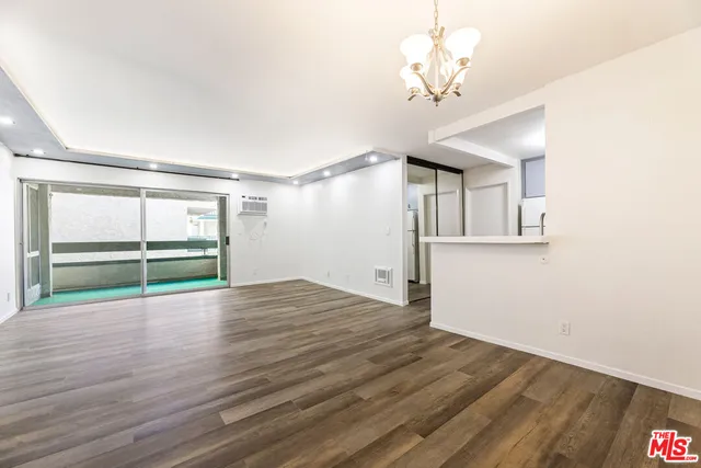 a view of a patio with dining table and chairs
