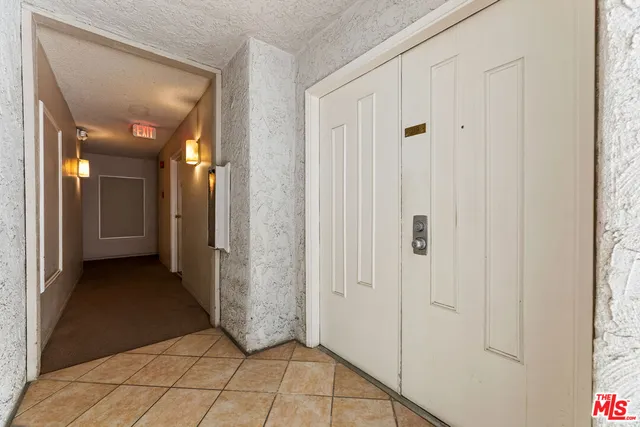 a spacious bedroom with a bed and a table in it