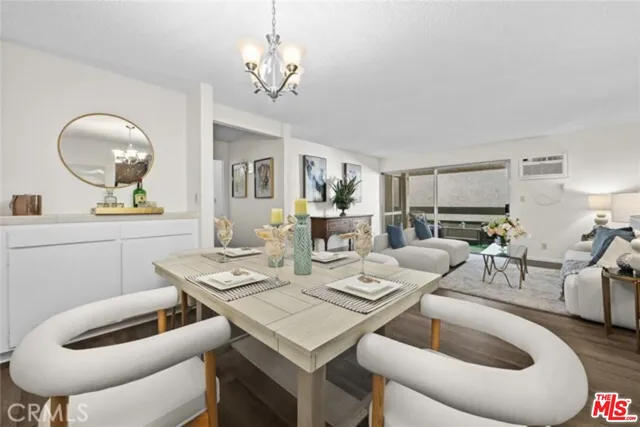 a living room with furniture a chandelier and a mirror