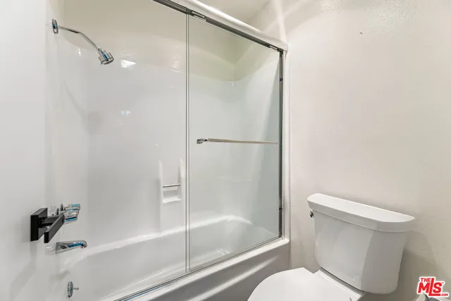 a bedroom with a large bed and a large window