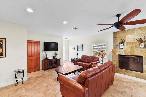 a living room with fireplace furniture and a flat screen tv