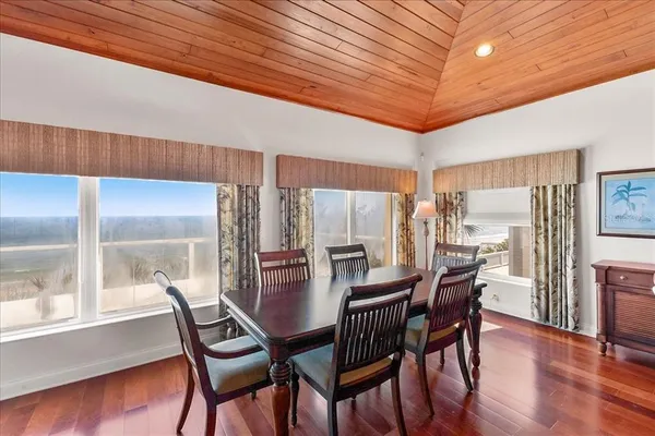 a dining room with furniture and wooden floor
