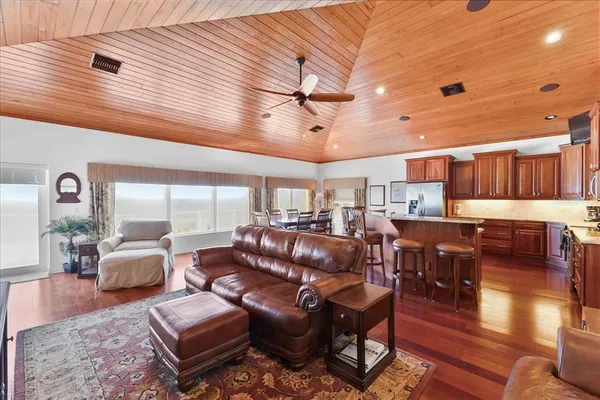 a living room with lots of furniture and wooden floors