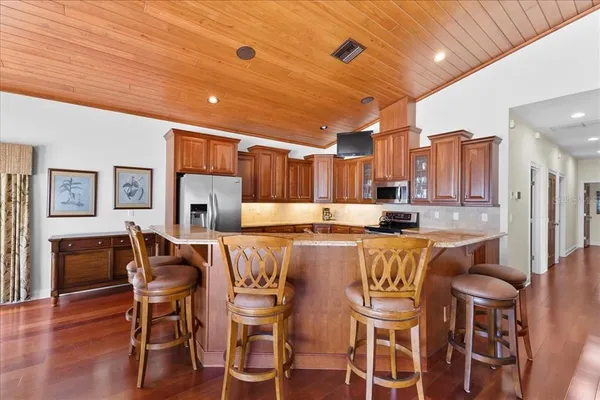 a large kitchen with a table and chairs
