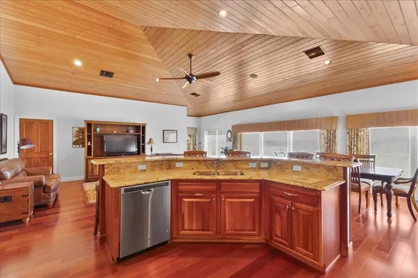 a open kitchen with stainless steel appliances granite countertop a stove and cabinets