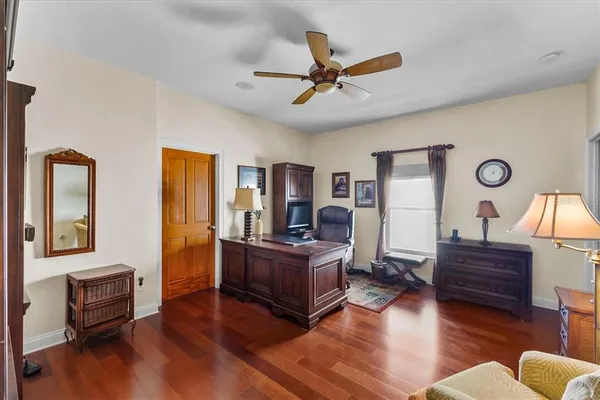 a living room with furniture and wooden floor