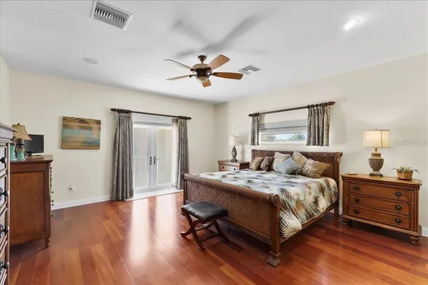 a bedroom with a bed and a chandelier