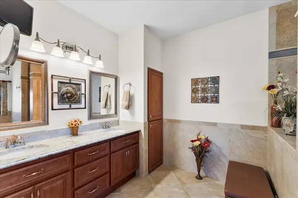 a living room with a couch and a potted plant