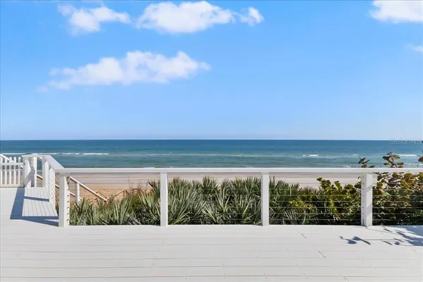 an aerial view of multiple houses with yard