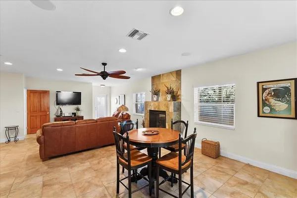 a view of a livingroom with furniture a flat screen tv and a window