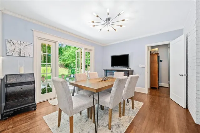 a view of a dining room with furniture window and wooden floor