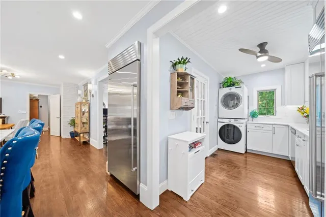 a view of a kitchen with a refrigerator and wooden floor