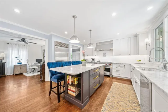 a kitchen with stainless steel appliances granite countertop a sink stove and refrigerator