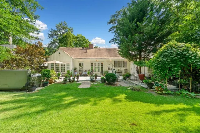 a front view of a house with garden and porch