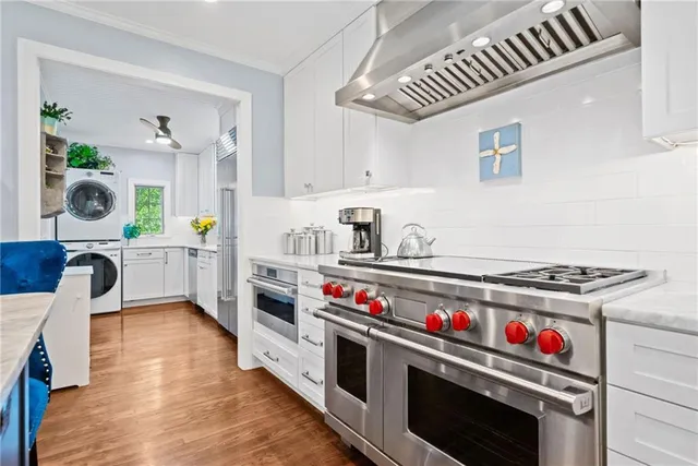 a kitchen with stove and cabinets