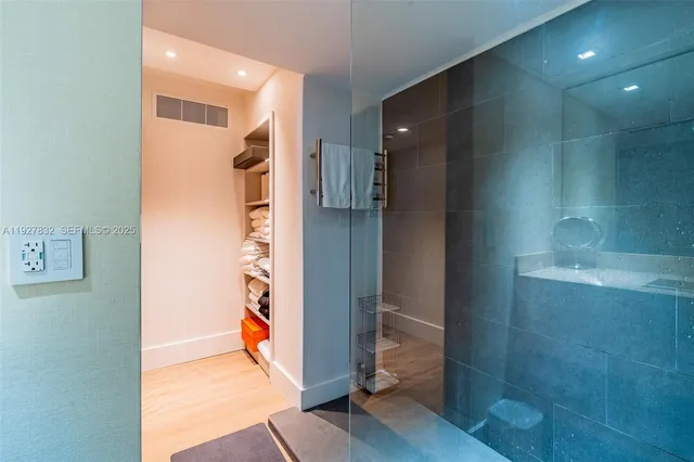 a view of a hallway with wooden shelves