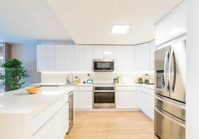 a kitchen with a sink a stove and refrigerator
