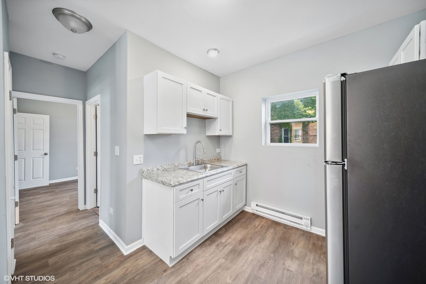 6601 South Green Street, Unit 2 Chicago, IL 60621 - Photo 7 of 11 a kitchen with a stove a sink and a refrigerator