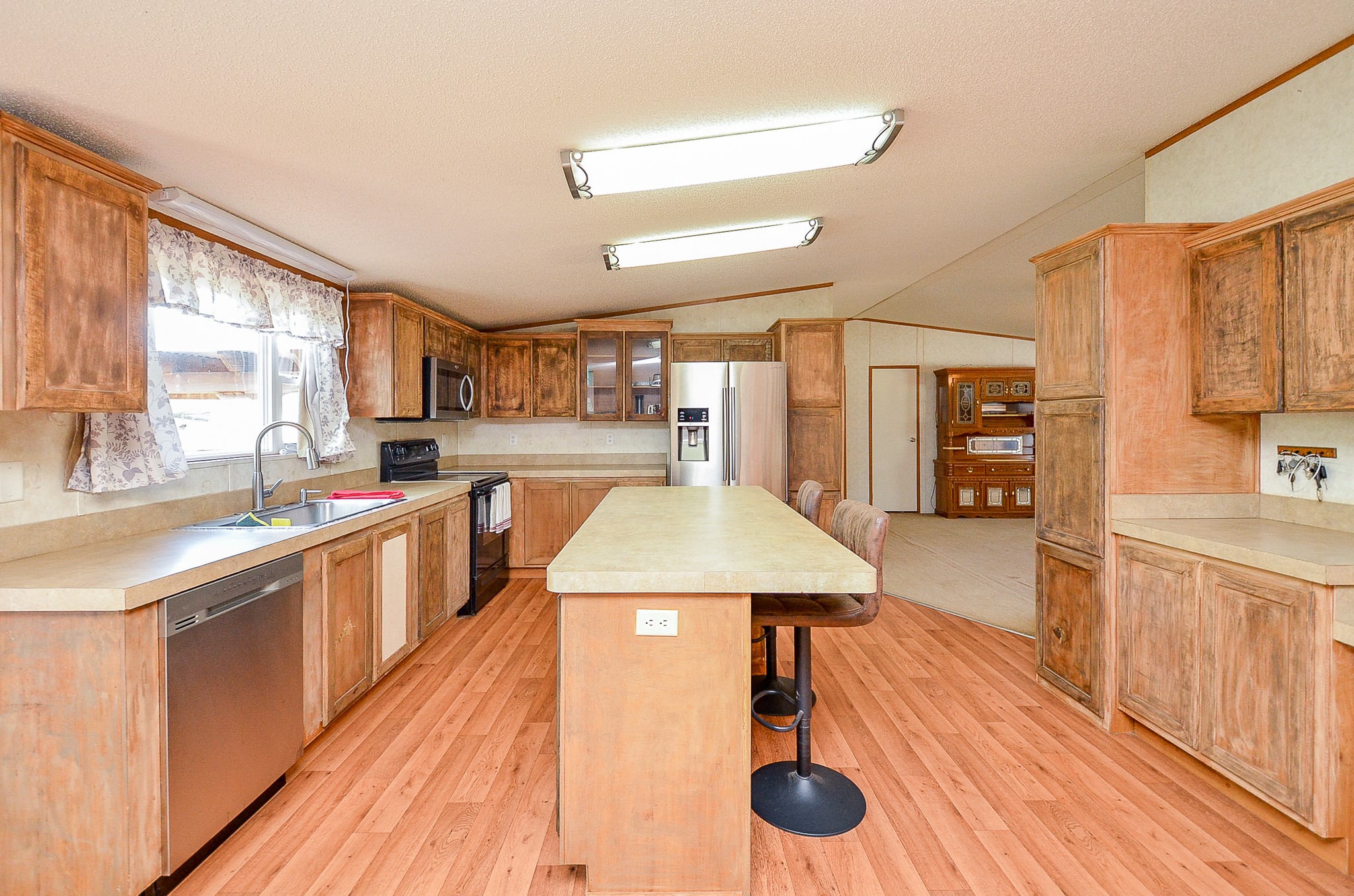 5440 7th Street Sheridan, TX 77475 - Photo 13 of 37 a large kitchen with lots of counter space and wooden floor