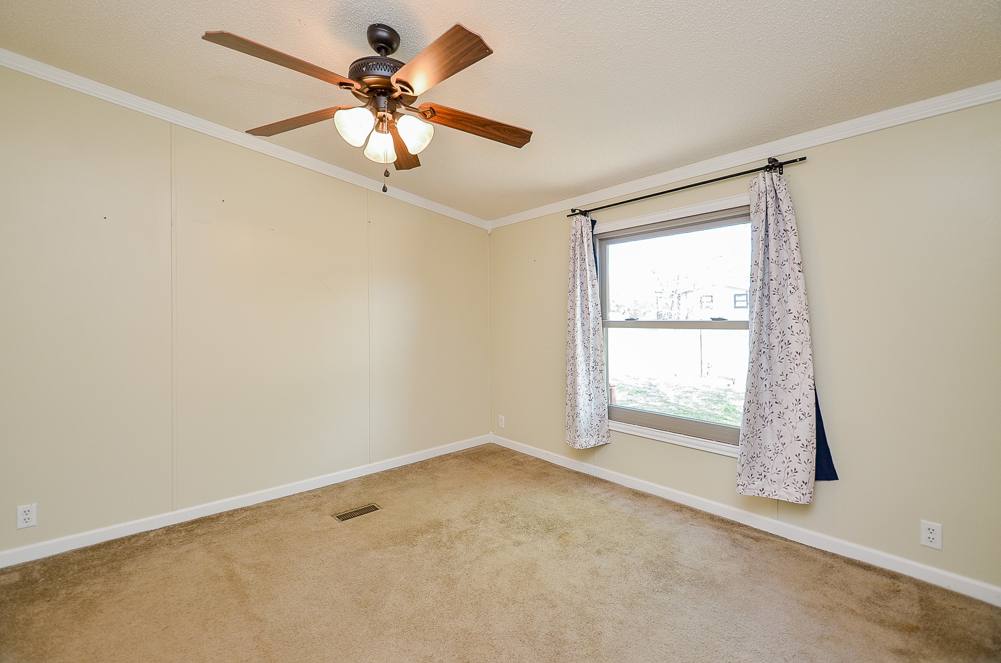 5440 7th Street Sheridan, TX 77475 - Photo 16 of 37 an empty room with a window and a ceiling fan