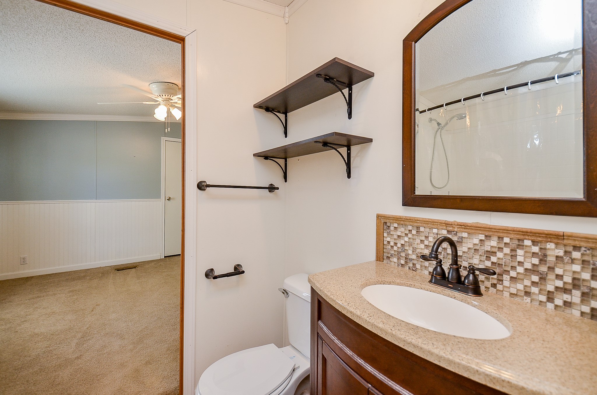 5440 7th Street Sheridan, TX 77475 - Photo 18 of 37 a bathroom with a sink a toilet and shower