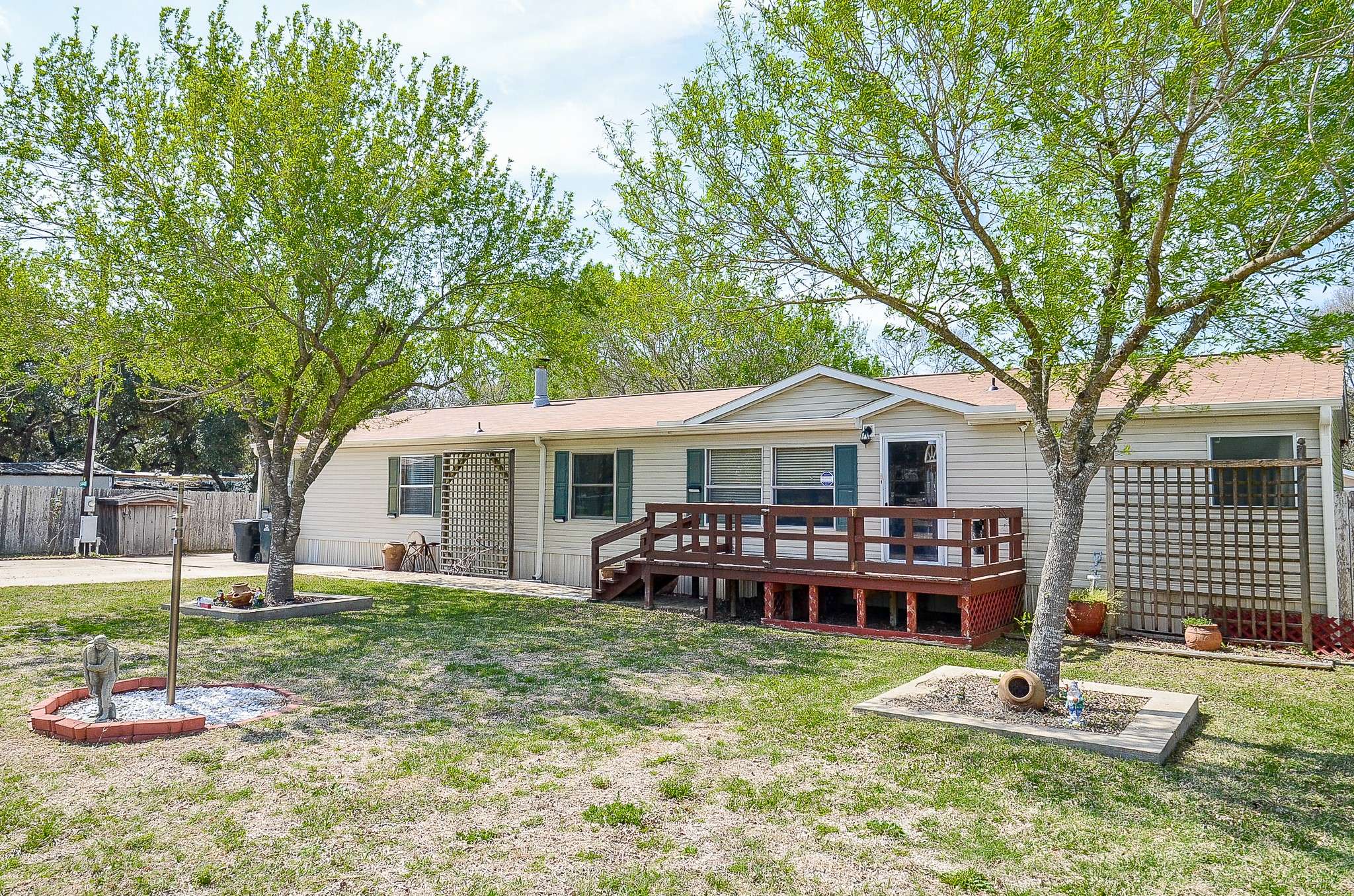 5440 7th Street Sheridan, TX 77475 - Photo 2 of 37 a front view of a house with a garden