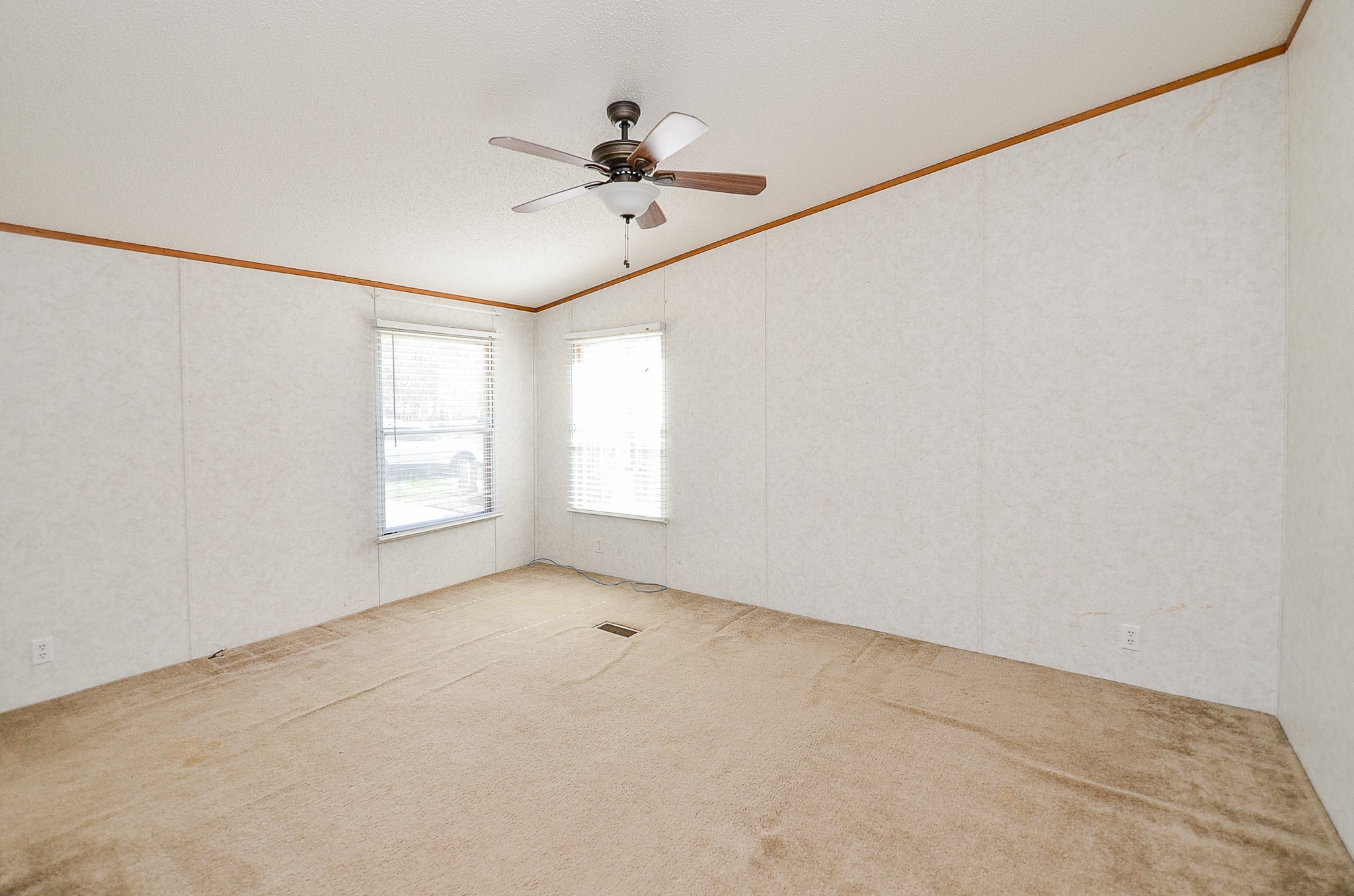5440 7th Street Sheridan, TX 77475 - Photo 21 of 37 an empty room with windows and fan